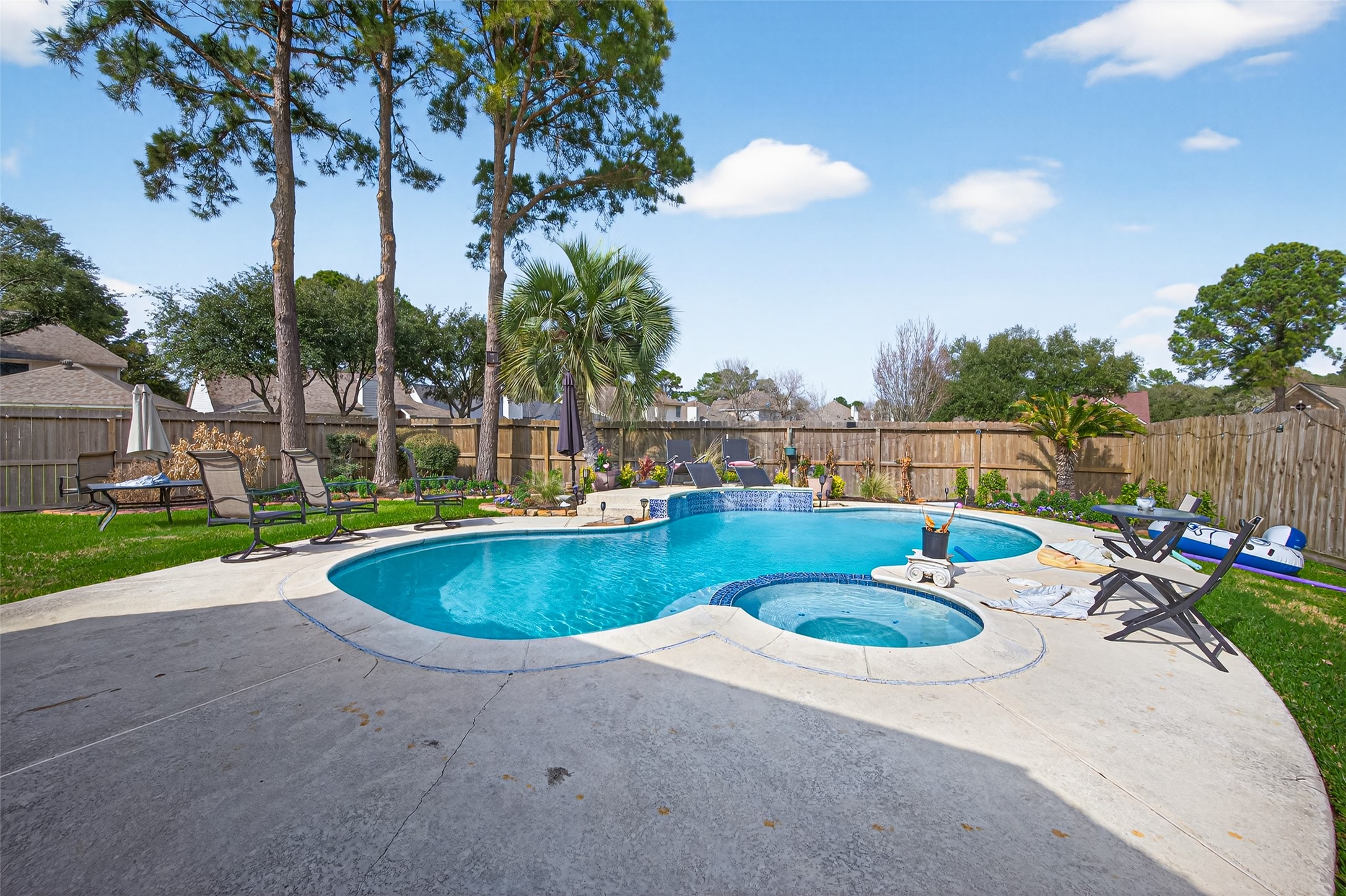 16902 Canyon Ridge Drive Spring, TX 77379 - Photo 41 of 43 a view of a swimming pool with a patio and a garden