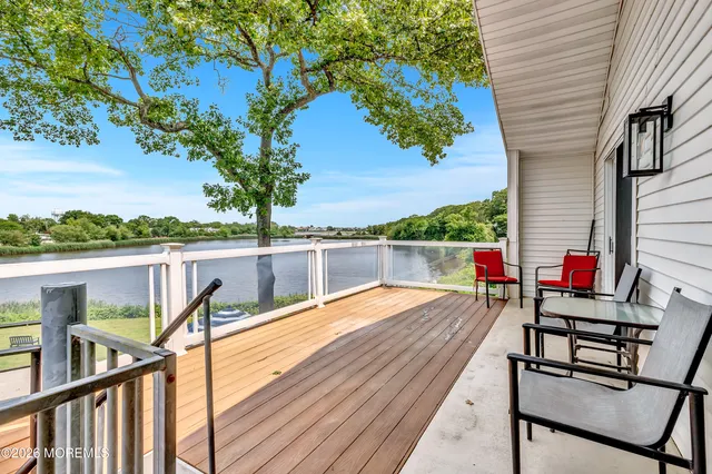 a view of deck with chairs and wooden fence