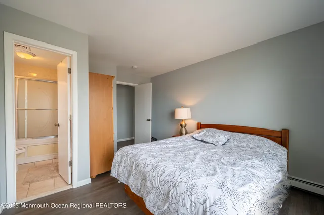 a bedroom with a bed and a painting on the wall