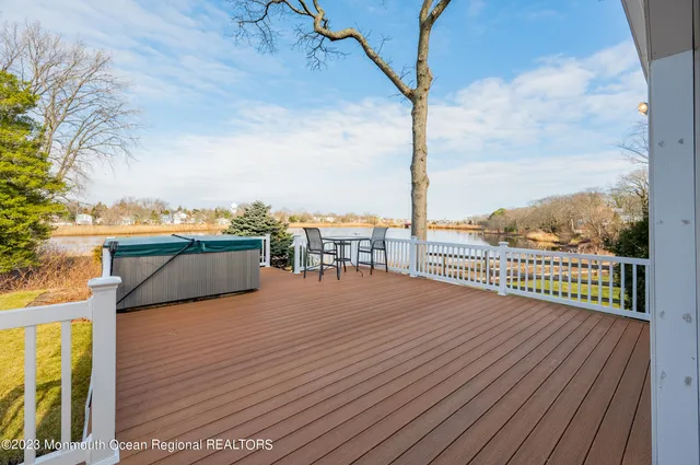 a view of roof deck with a barbeque and wooden stairs