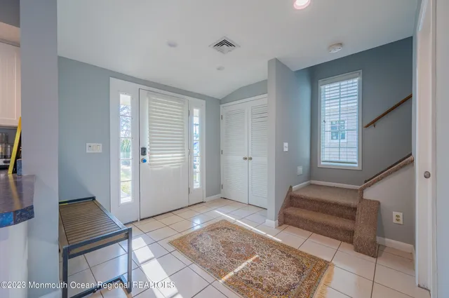 a view of front door with furniture and a window