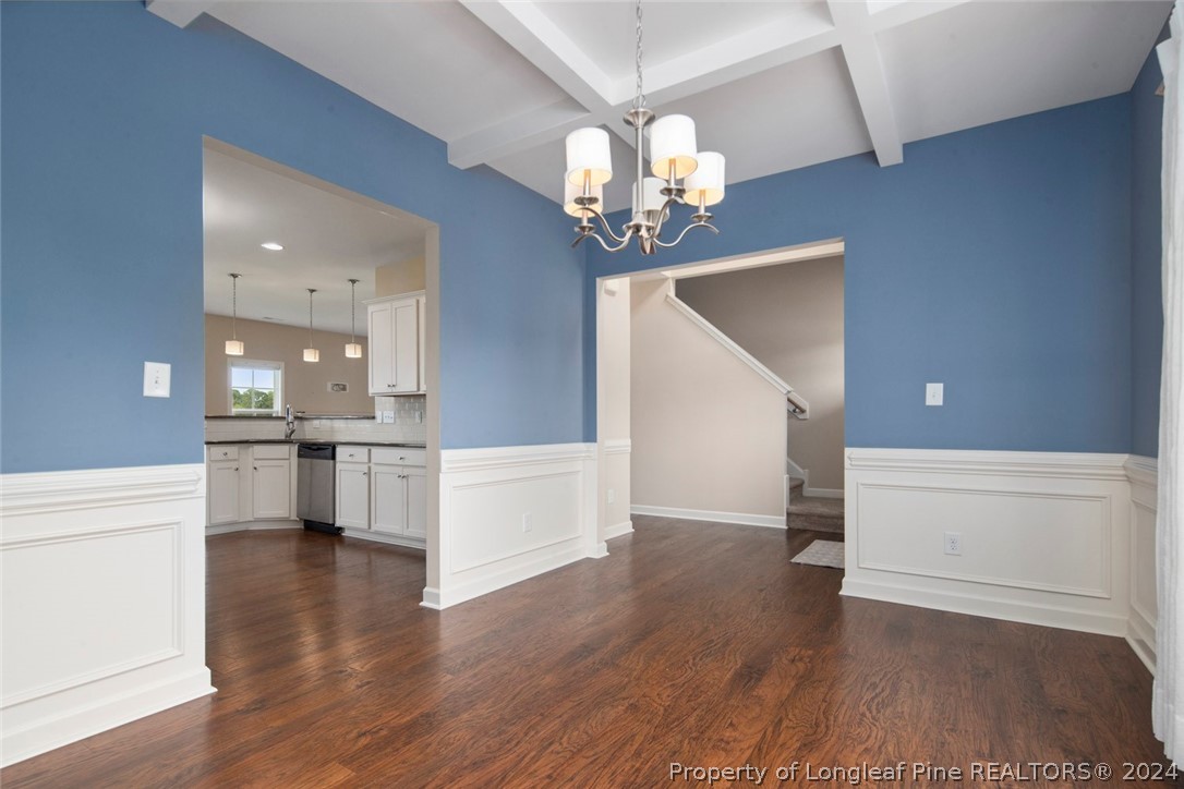 3631 Thrower Road Hope Mills, NC 28348 - Photo 11 of 50 a view of a dining hall with stainless steel appliances wooden floor and chandelier
