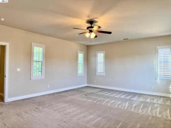 a view of a pathway gate with wooden fence