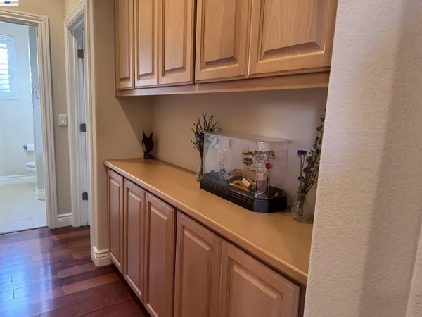 a view of a hallway with wooden floor and closet
