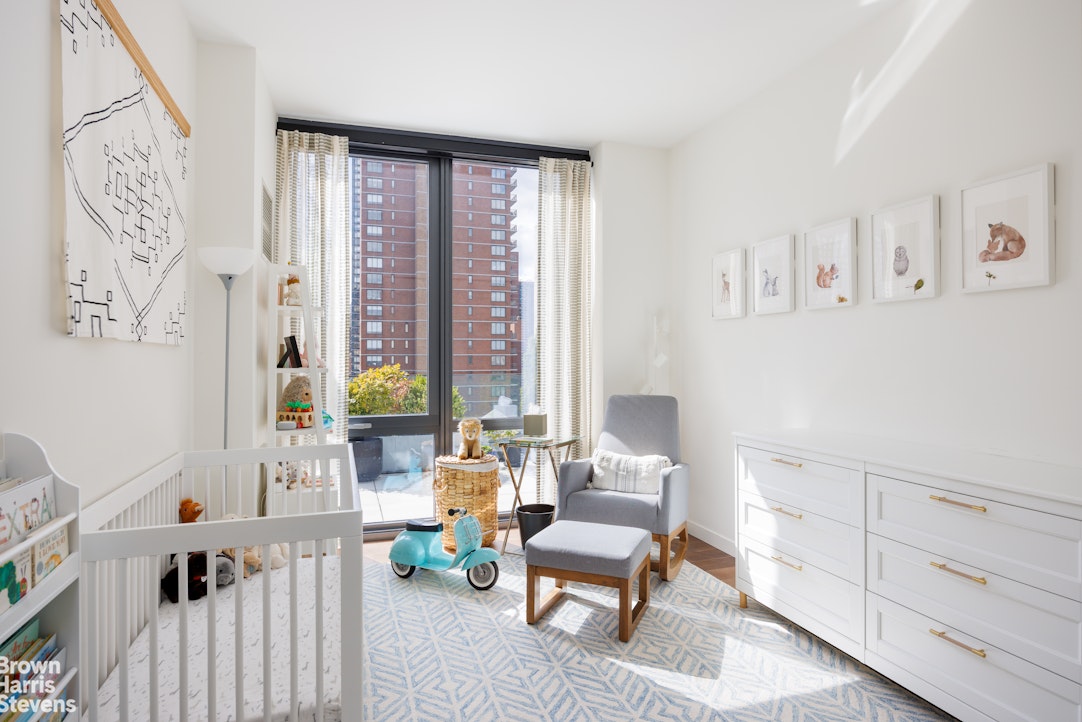 302 East 96th Street, Unit PH1 Manhattan, NY 10128 - Photo 10 of 13 a living room with furniture and a large window