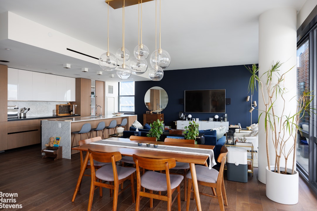 302 East 96th Street, Unit PH1 Manhattan, NY 10128 - Photo 3 of 13 a view of a dining room with furniture and wooden floor
