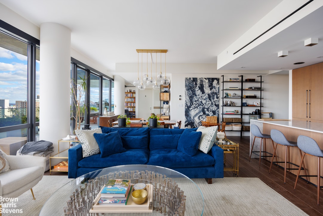 302 East 96th Street, Unit PH1 Manhattan, NY 10128 - Photo 4 of 13 a living room with furniture and wooden floor