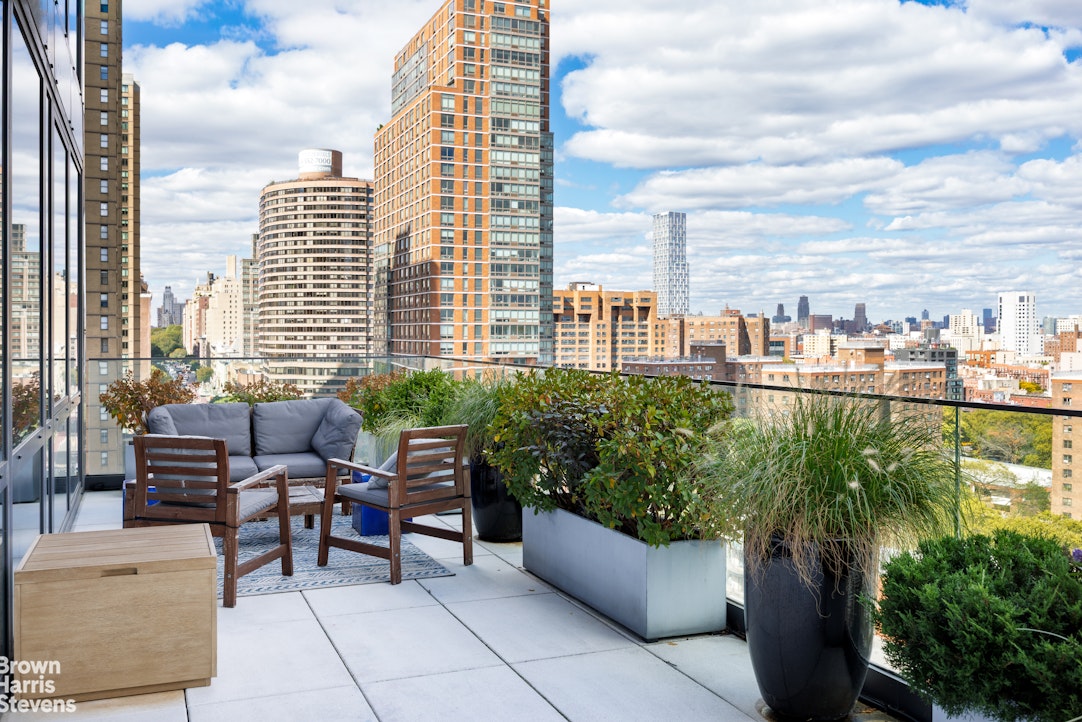 302 East 96th Street, Unit PH1 Manhattan, NY 10128 - Photo 5 of 13 a view of a balcony with chairs and a table