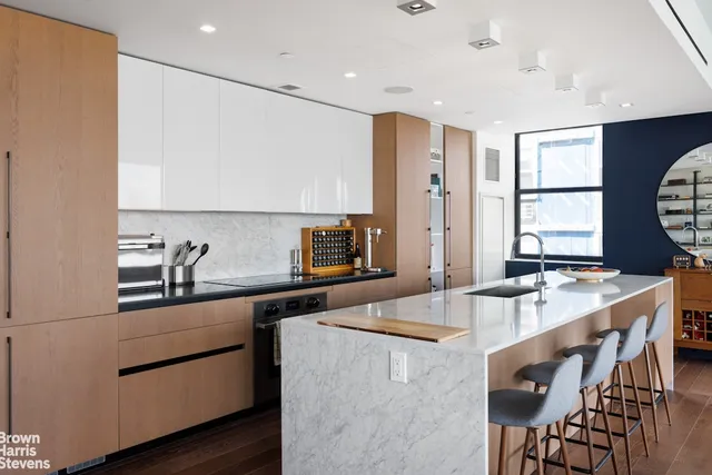 a kitchen with stainless steel appliances granite countertop a sink a stove and a refrigerator