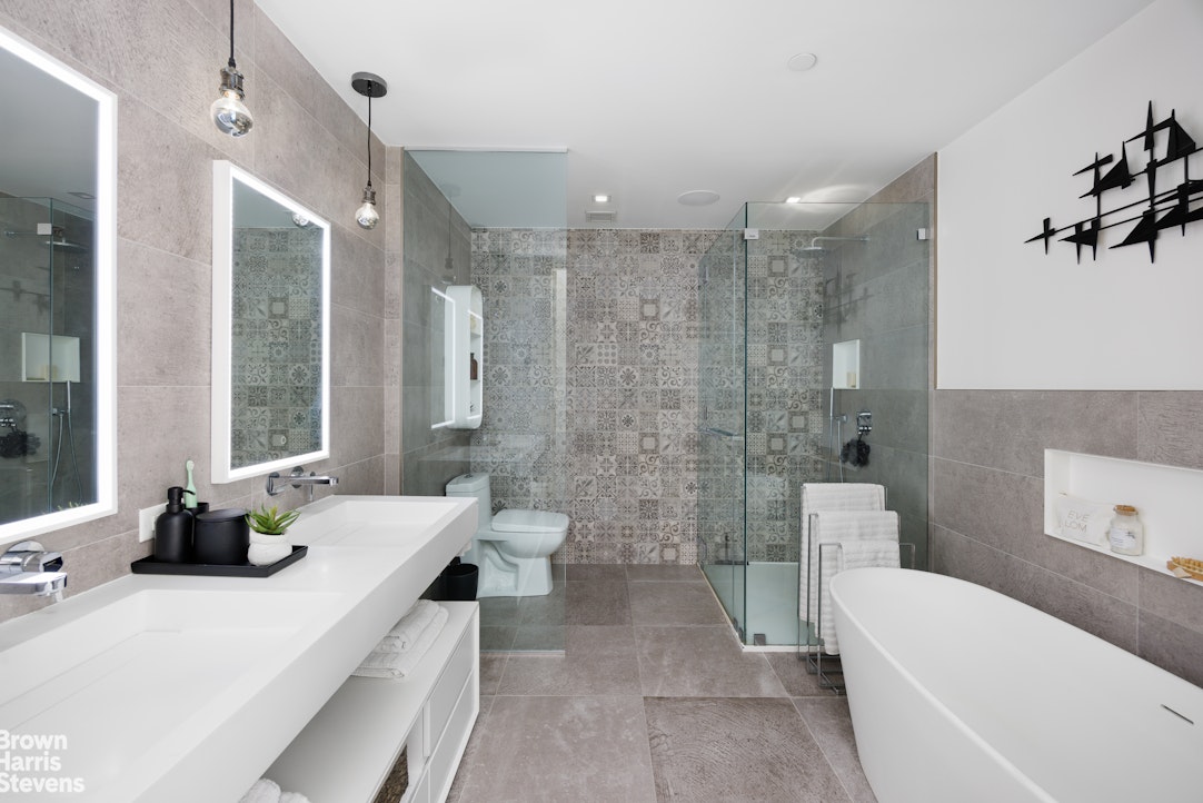 302 East 96th Street, Unit PH1 Manhattan, NY 10128 - Photo 8 of 13 a bathroom with a double vanity sink toilet and bathtub