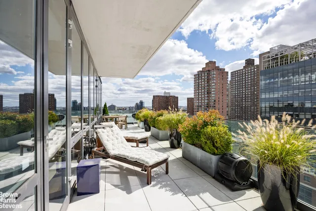 a view of a patio with couches and potted plants