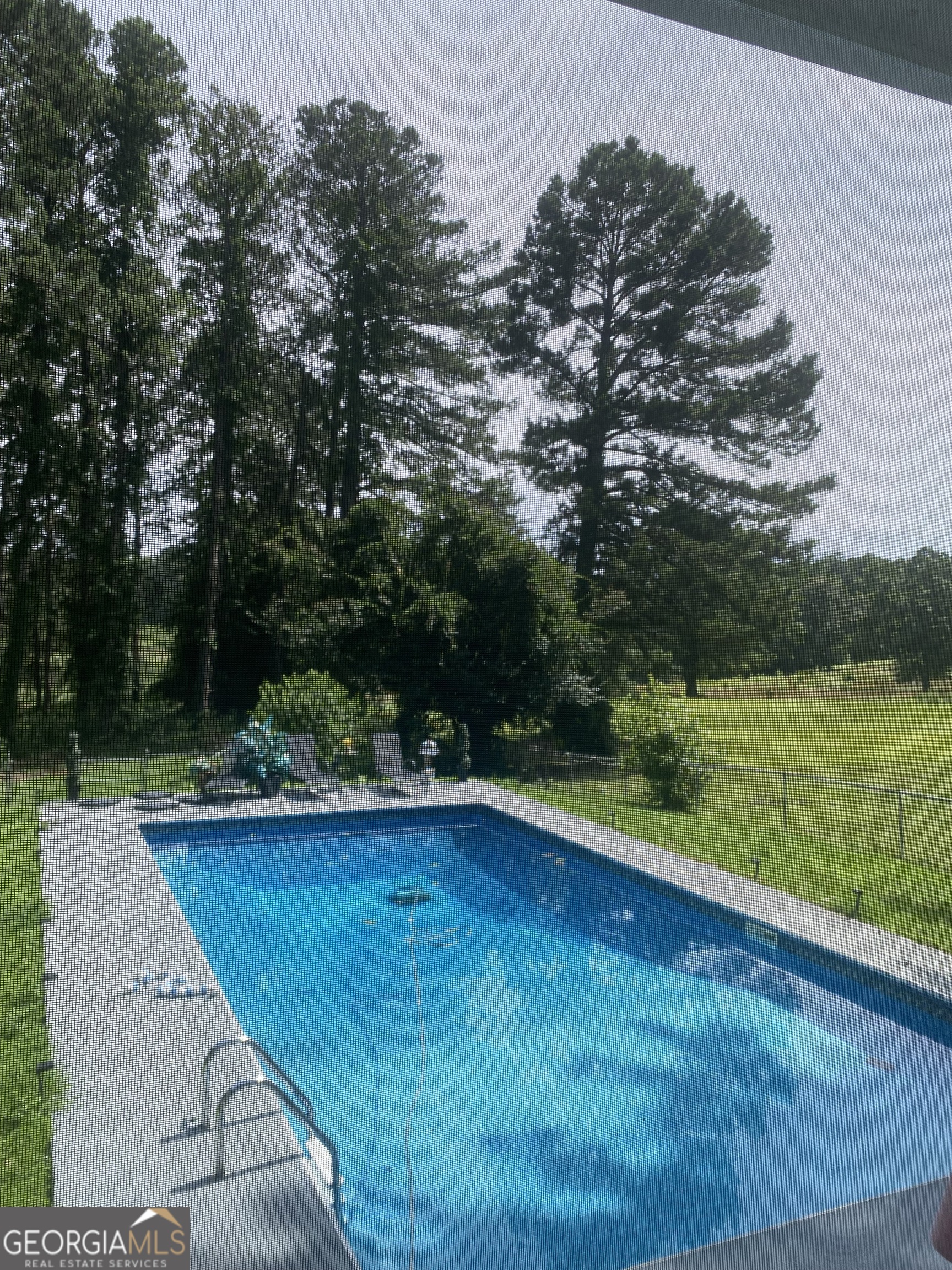 7383 Pleasant Hill Road Lithonia, GA 30058 - Photo 16 of 18 a view of a swimming pool with a yard