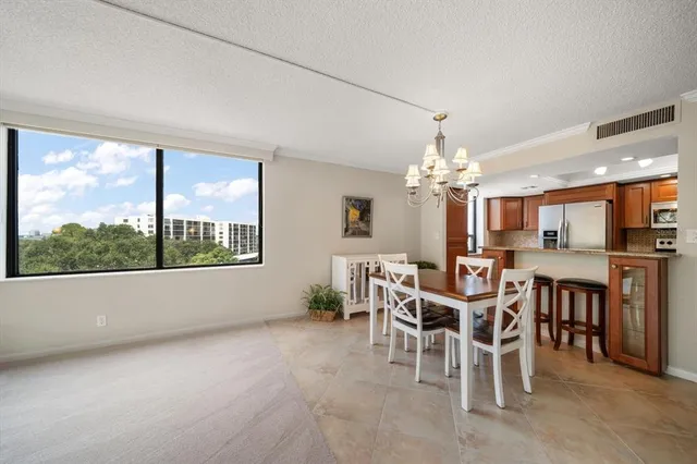 a dining room with furniture a floor to ceiling window and a fireplace