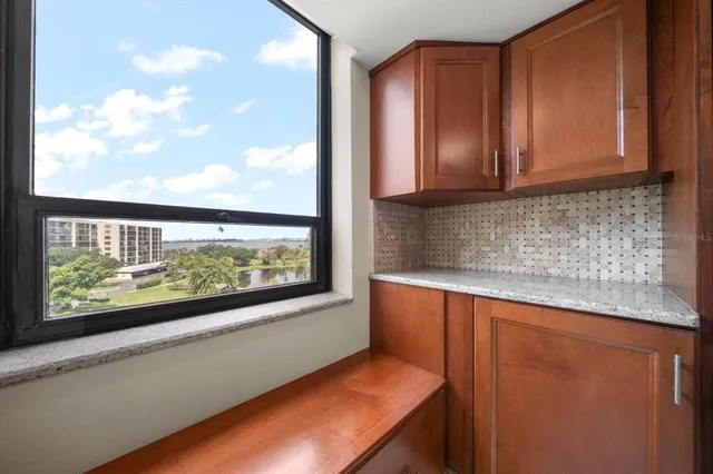 a view of a kitchen with wooden floor and a window