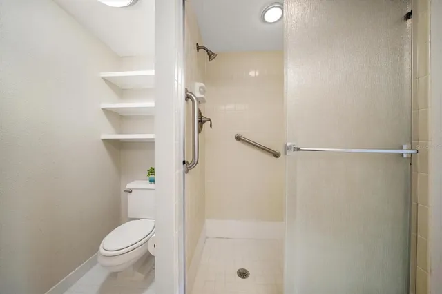 a bathroom with a toilet and a shower