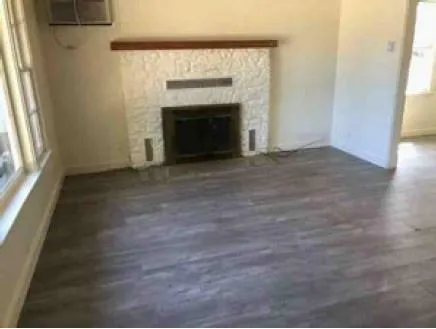 a kitchen with granite countertop a sink stove and cabinets