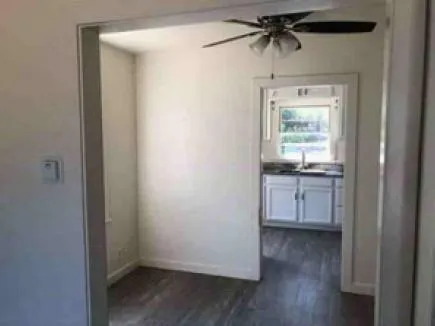 a kitchen with a stove and a white wooden cabinets