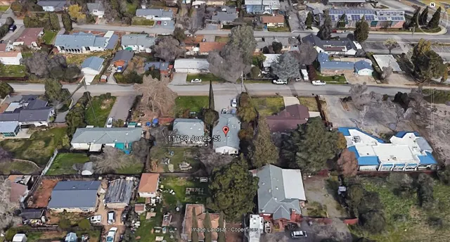 a couple of cars parked in front of a house