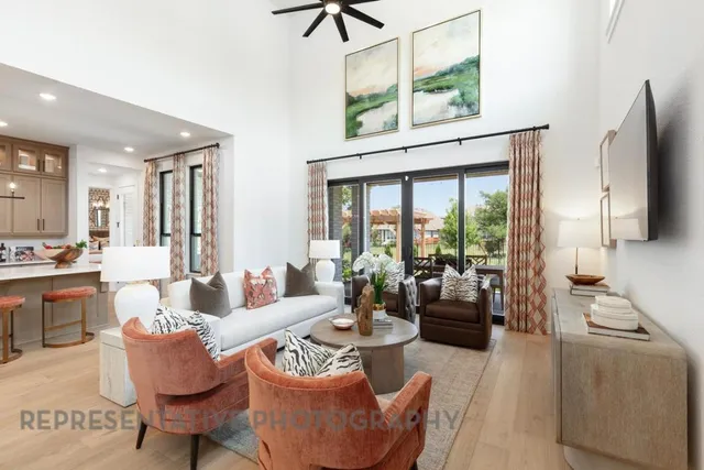 a living room with furniture fireplace and a large window