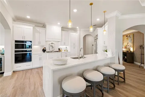 a large kitchen with a table and chairs