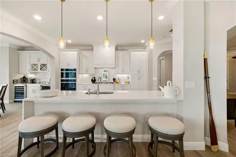 a large kitchen with a table and chairs