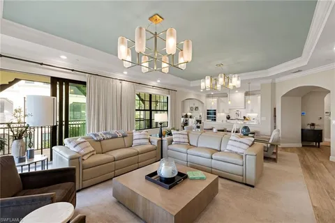 a living room with furniture chandelier and a chandelier