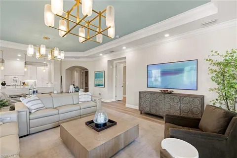 a living room with furniture a rug and a chandelier