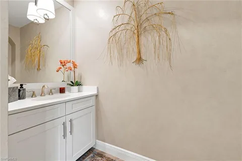 a bathroom with a sink vanity and a mirror