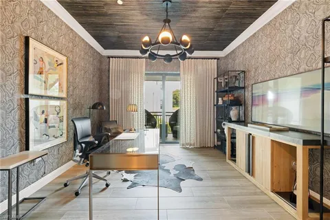 a open kitchen with stainless steel appliances granite countertop a stove top oven a dining table and chairs with wooden floor