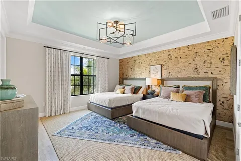 a bedroom with two beds and a window