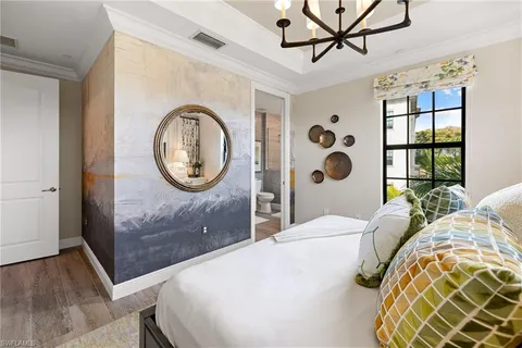 a bedroom with a bed and a mirror