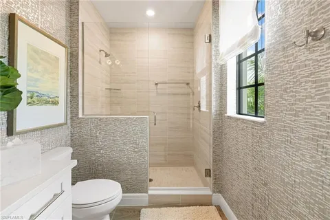 a bathroom with a shower and a toilet