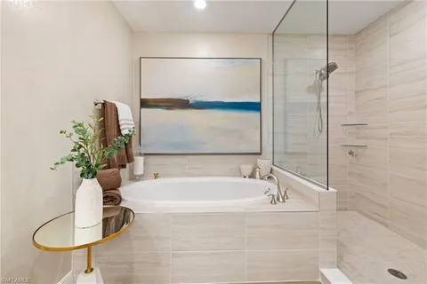 a bathroom with a tub and a shower
