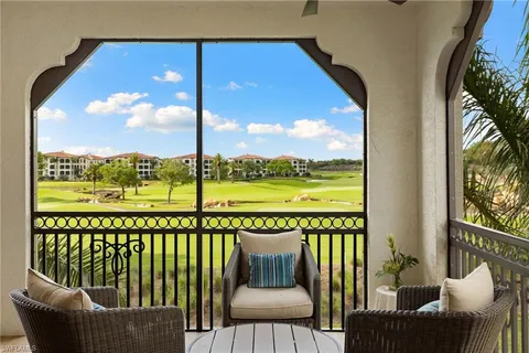 a view of a chair and tables in the balcony
