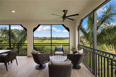 a balcony with furniture and a potted plant