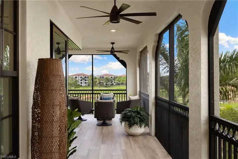 a view of a porch with furniture and a potted plant