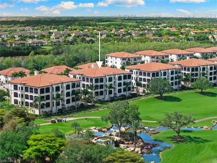 an aerial view of a house with outdoor space lake view and an ocean view
