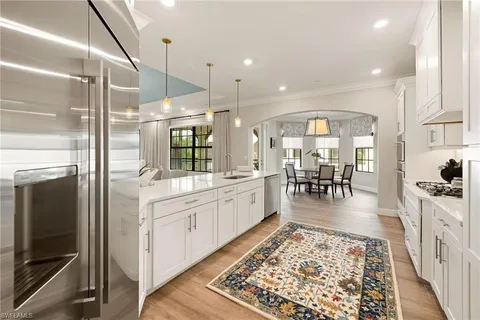 a large white kitchen with a large window