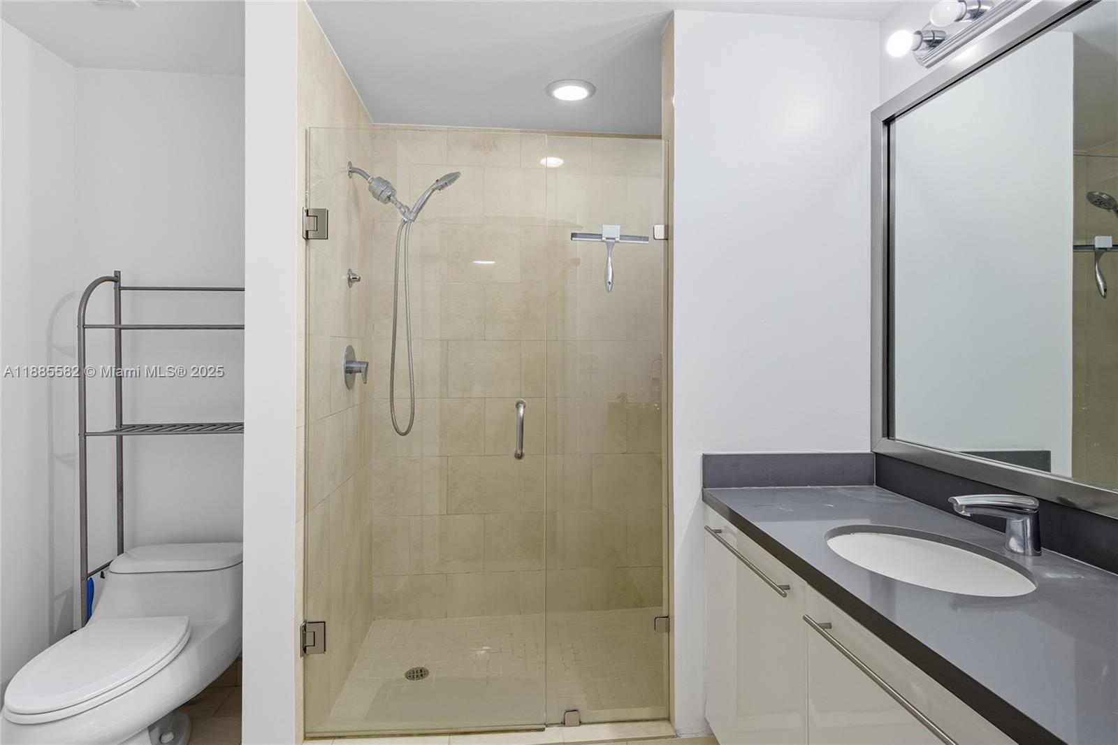 90 Southwest 3rd Street, Unit 2214 Miami, FL 33130 - Photo 6 of 9 a bathroom with a granite countertop sink toilet and shower