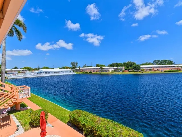 a view of a lake with lawn chairs