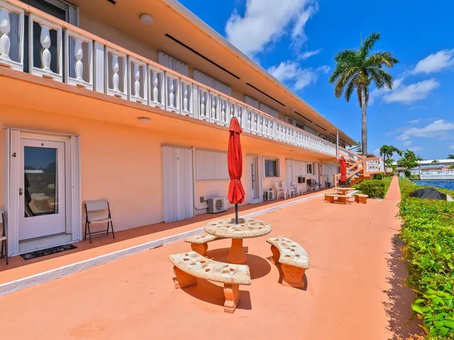 a swimming pool with an outdoor seating and house