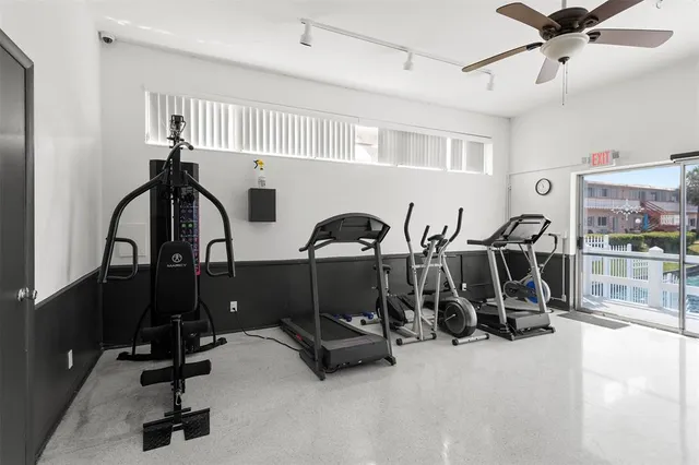 a room with pool table and windows