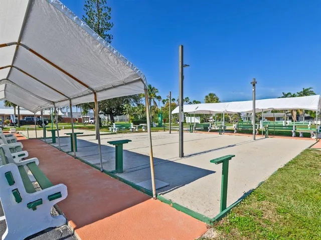 a view of a swimming pool and lounge chairs