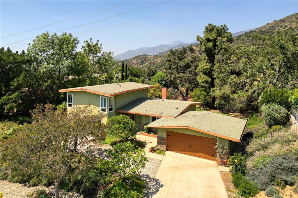 a view of a house with a yard and sitting area