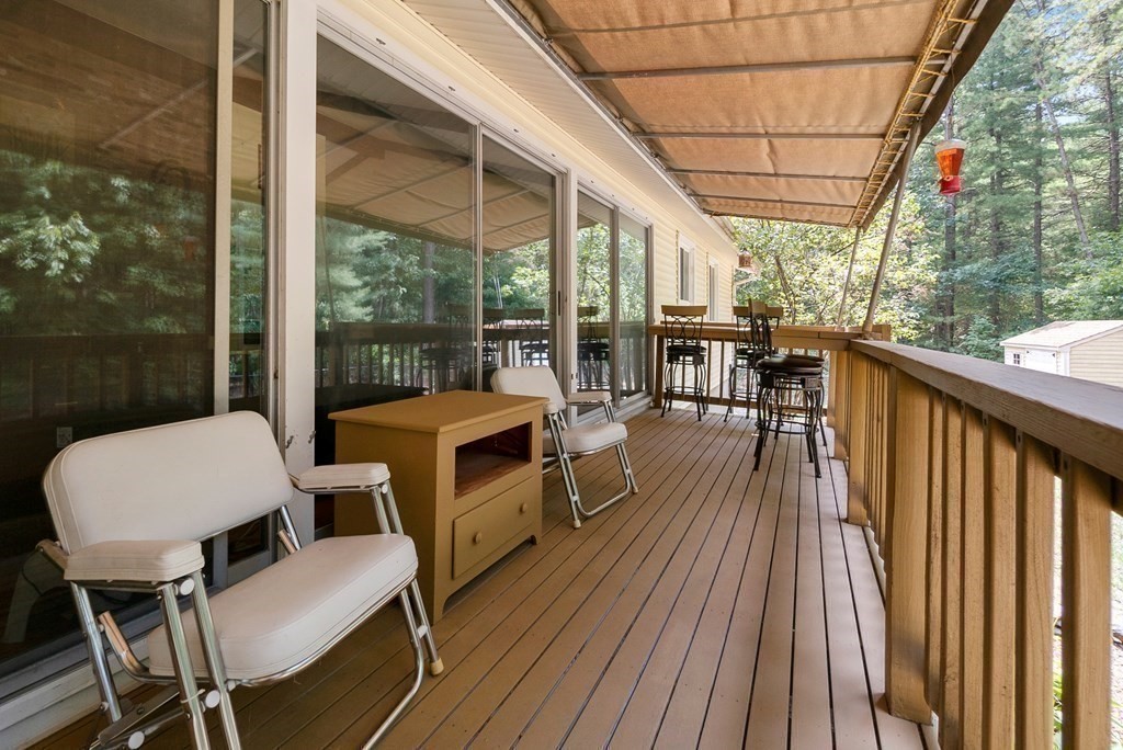 96 Old Mill Road Harvard, MA 01451 - Photo 15 of 32 a view of a patio with wooden floor table and chairs