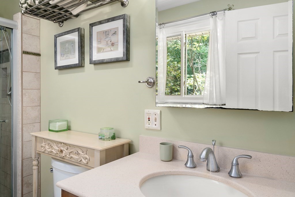 96 Old Mill Road Harvard, MA 01451 - Photo 19 of 32 a bathroom with a granite countertop sink and a bathtub