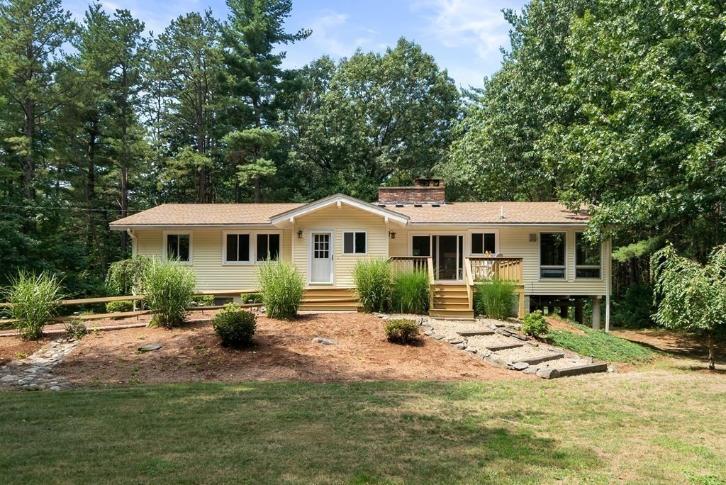 96 Old Mill Road Harvard, MA 01451 - Photo 3 of 32 a front view of a house with a yard patio and fire pit