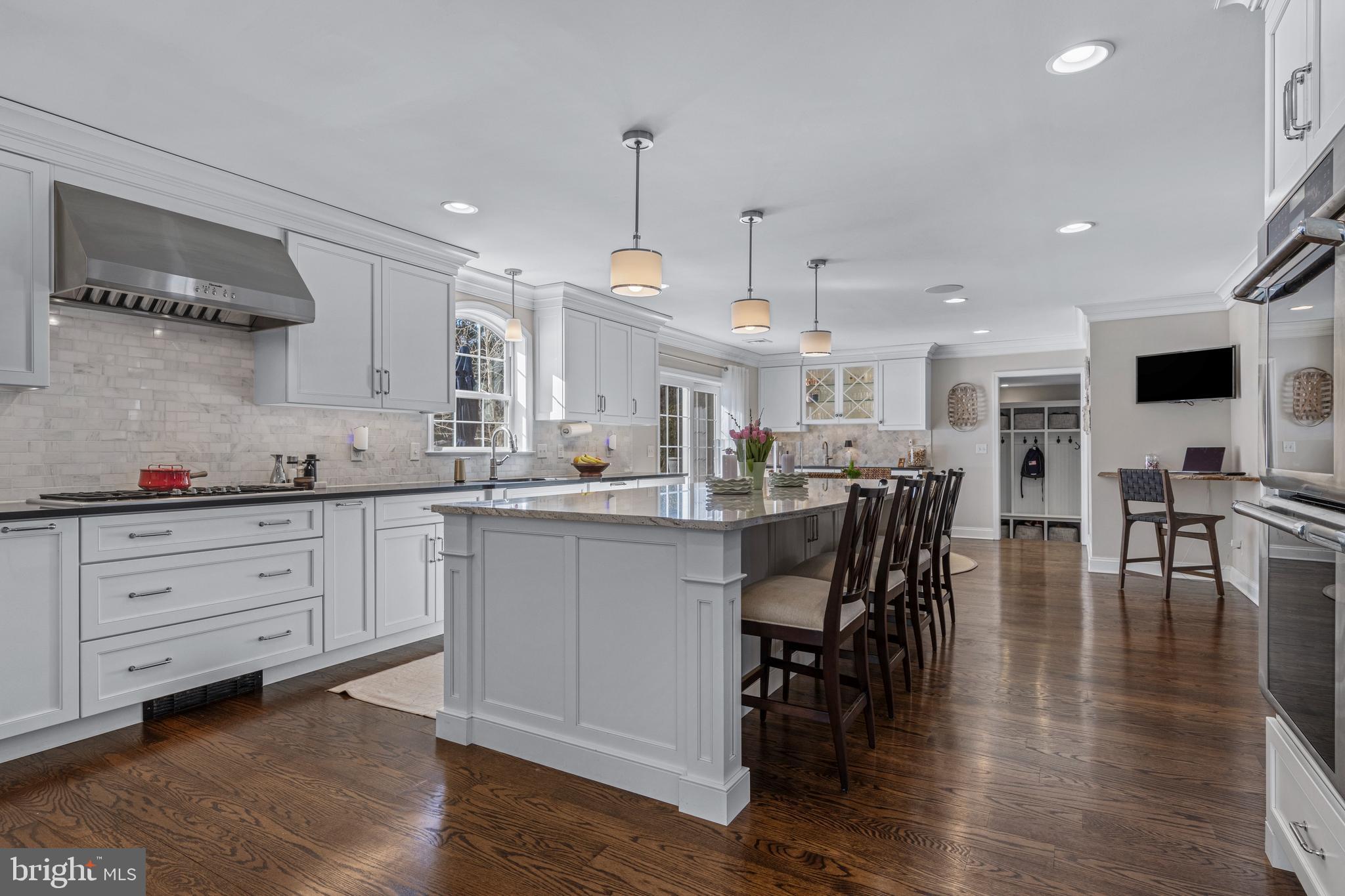 1012 Waltham Road Berwyn, PA 19312 - Photo 12 of 55 a kitchen with stainless steel appliances kitchen island granite countertop a table chairs sink and cabinets