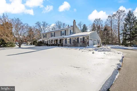 a view of a house with snow on the road