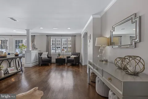a living room with furniture and a piano